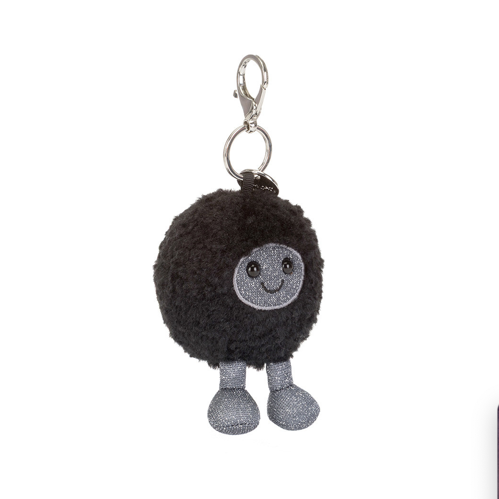 Black hole-shaped bag charm with a smiling face on a white background