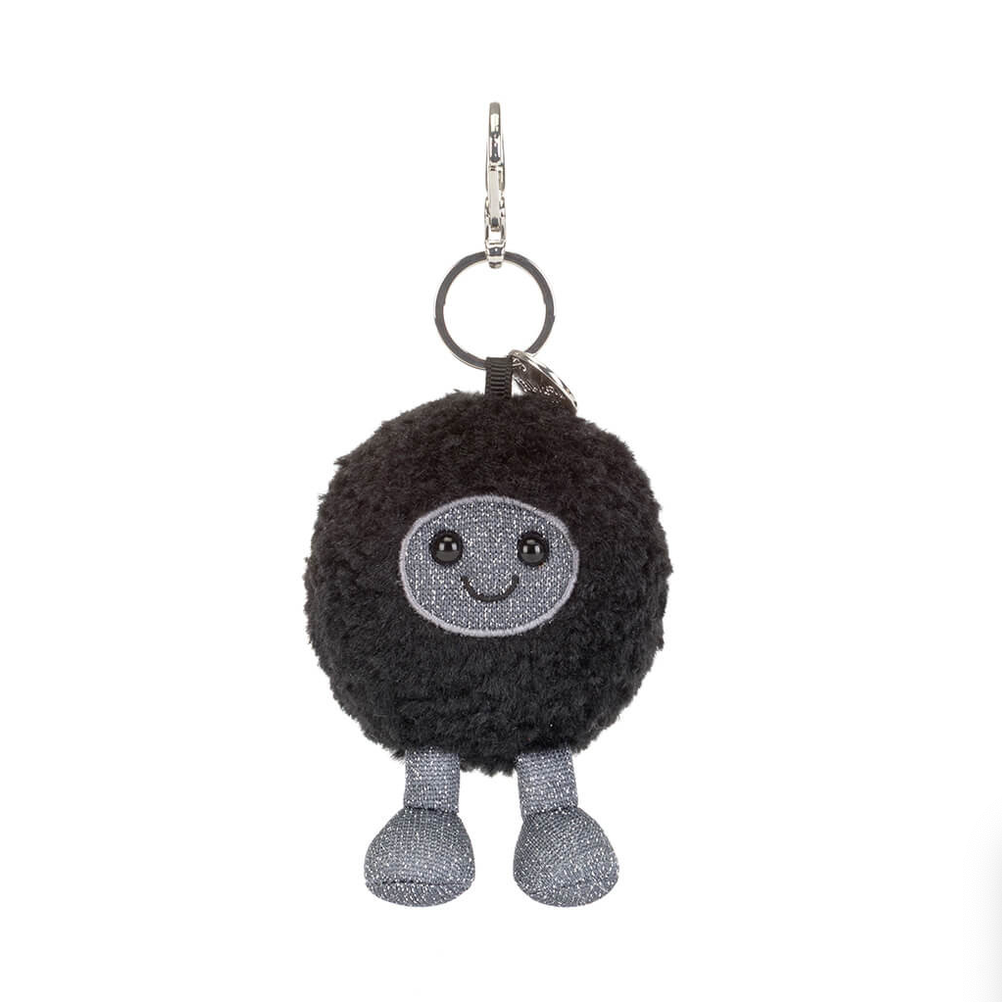 Black hole-shaped bag charm with a smiling face on a white background