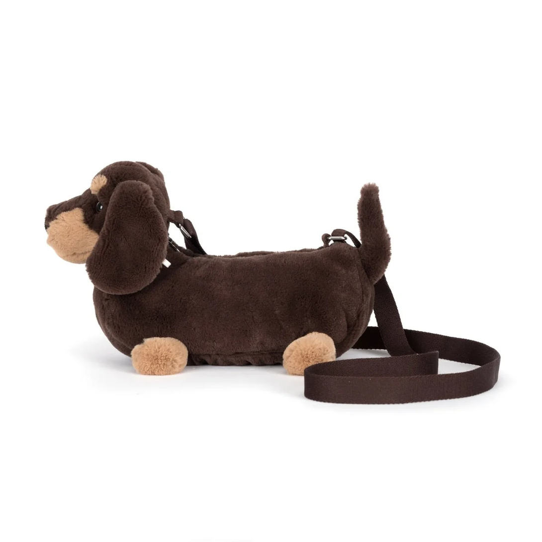Brown dachshund-shaped bag with a leash on a white background