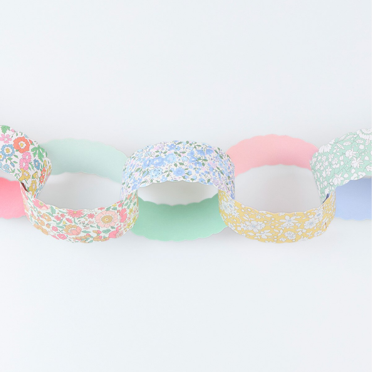 Set of colorful paper rings with floral patterns on a white background