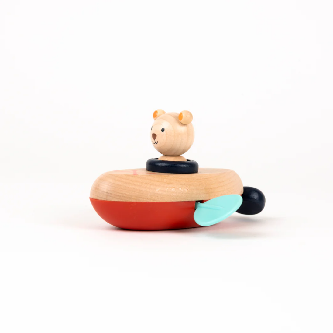 Wooden toy boat with a bear figure on a white background