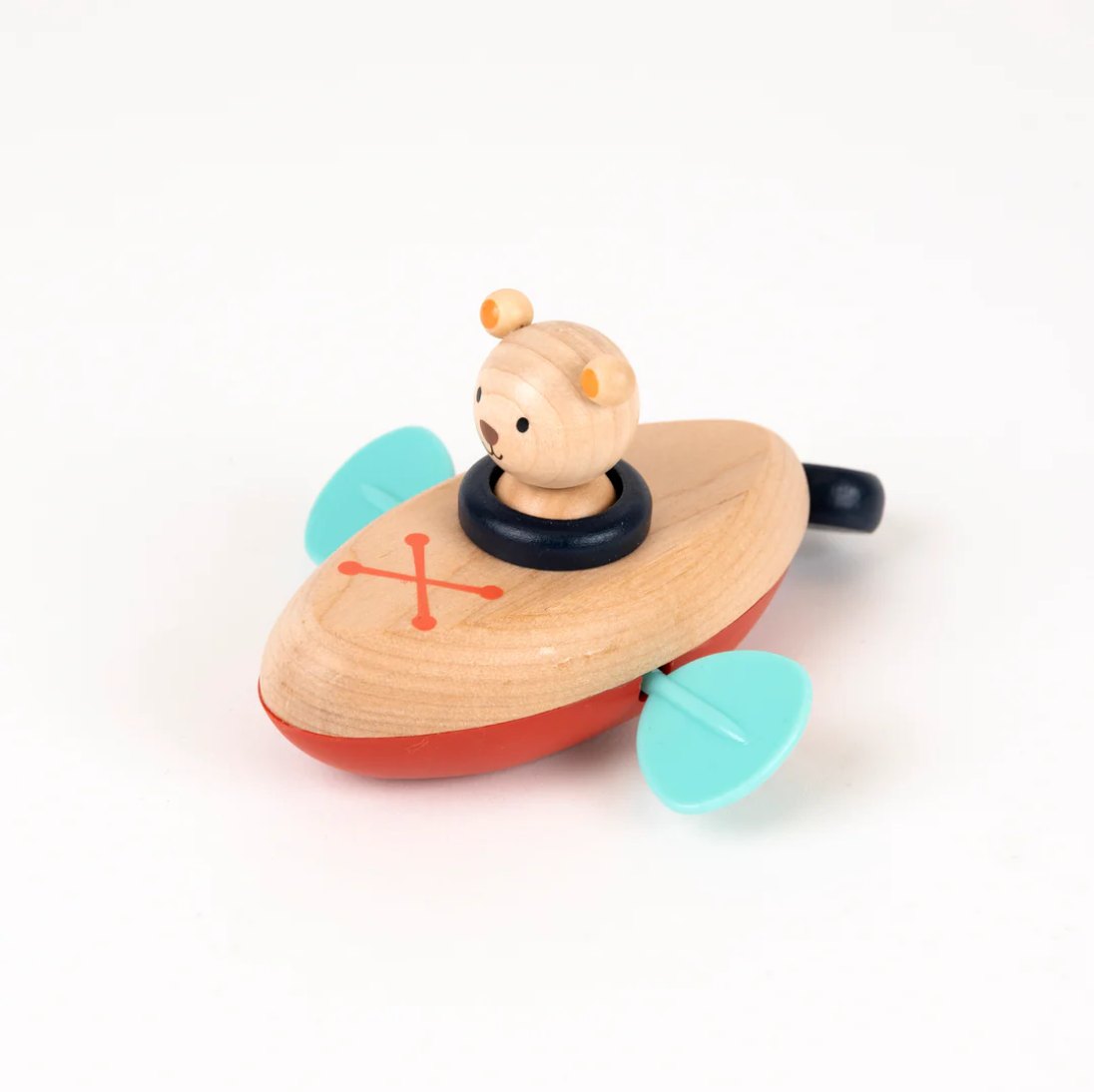 Wooden toy boat with a teddy bear on a white background