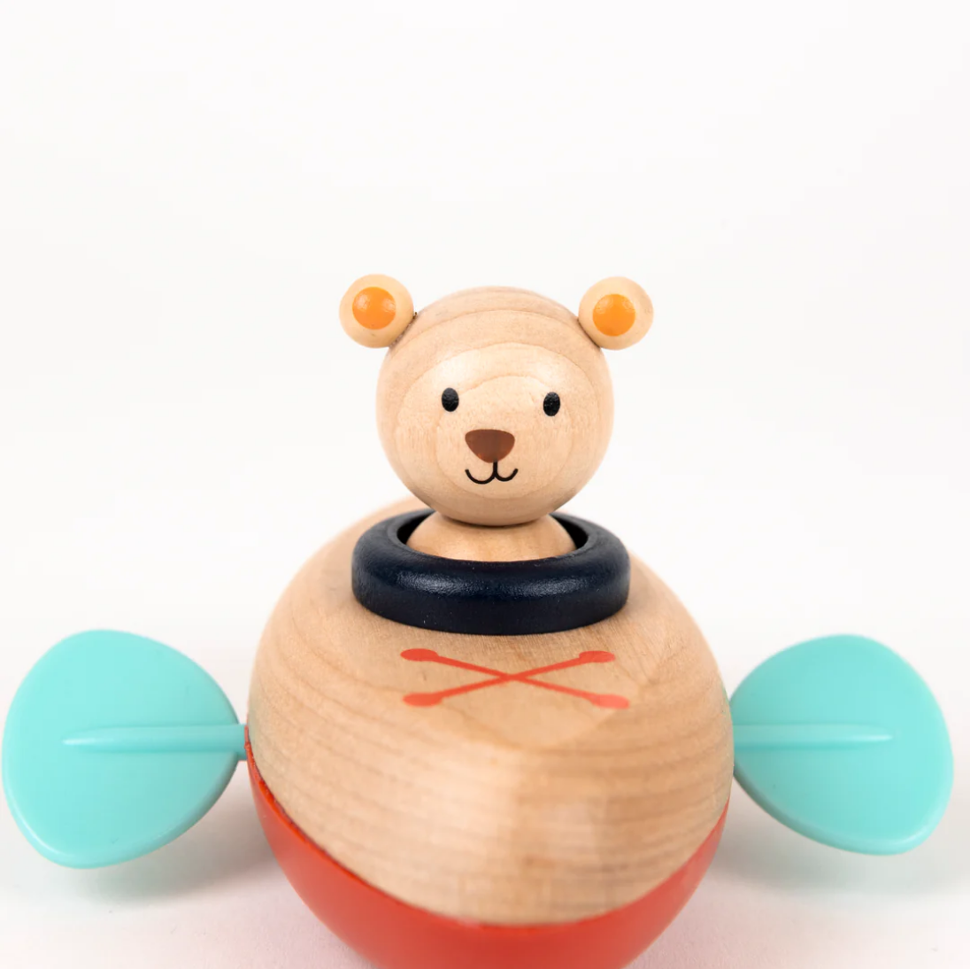 Wooden toy with a bear face and colorful elements on a white background