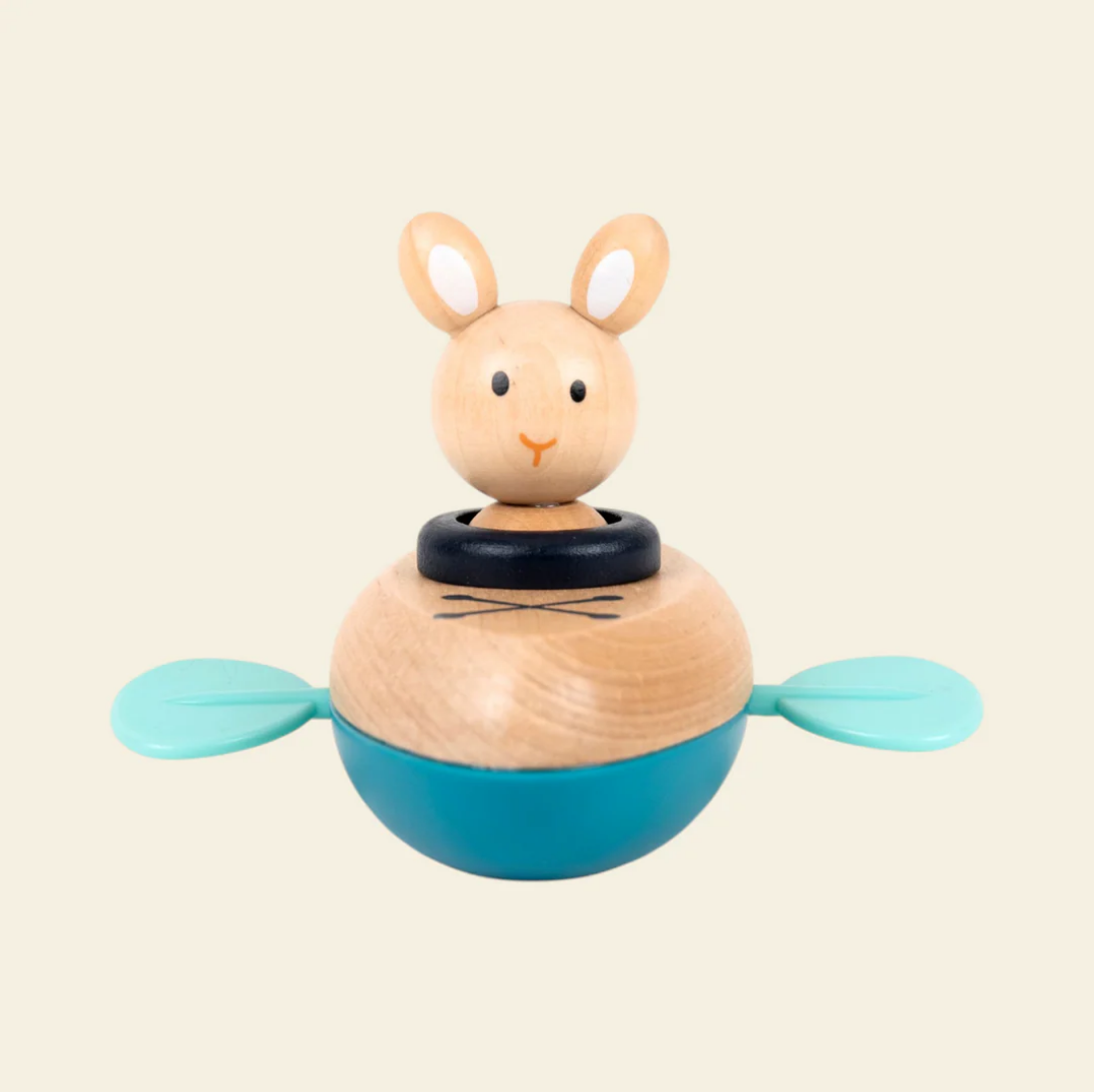 Wooden toy rabbit with a blue base on a beige background