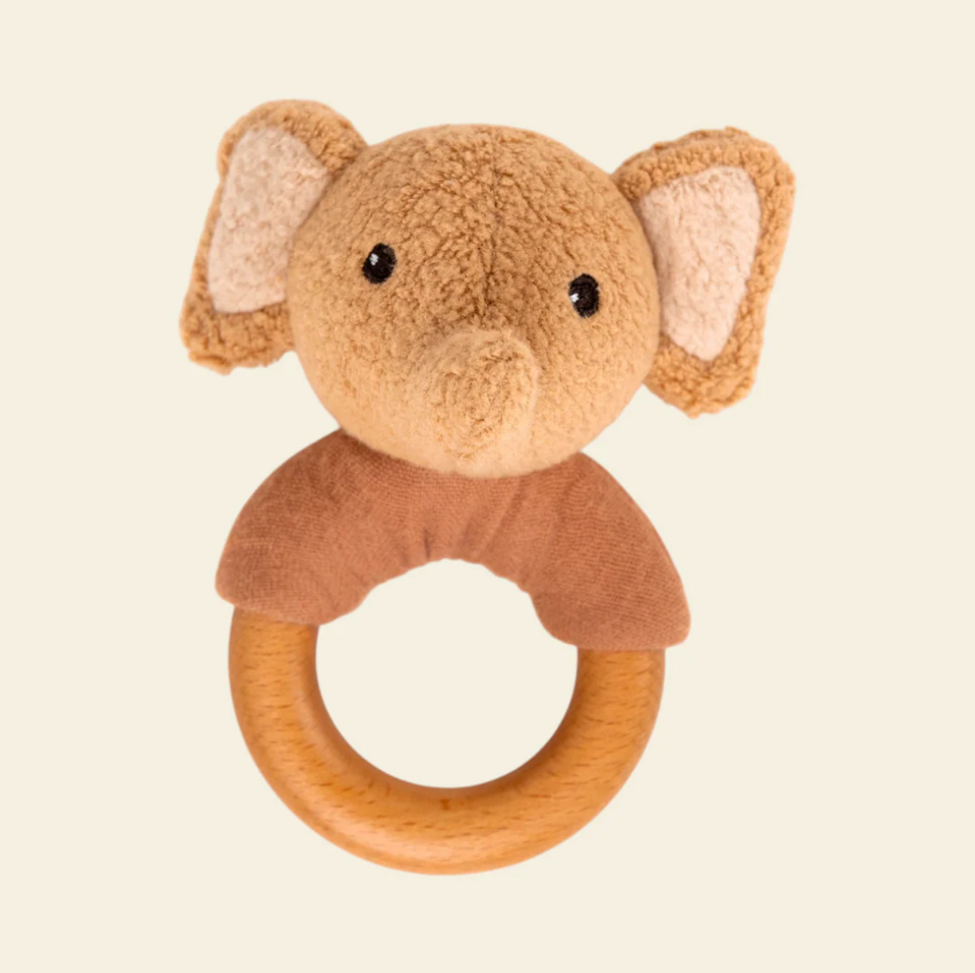 Plush elephant rattle with wooden ring on a beige background