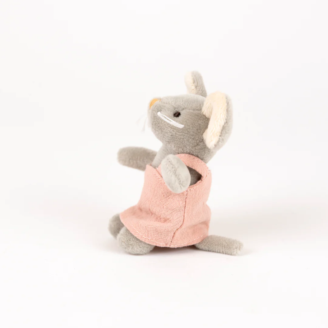 Plush toy rhino in a pink outfit on a white background