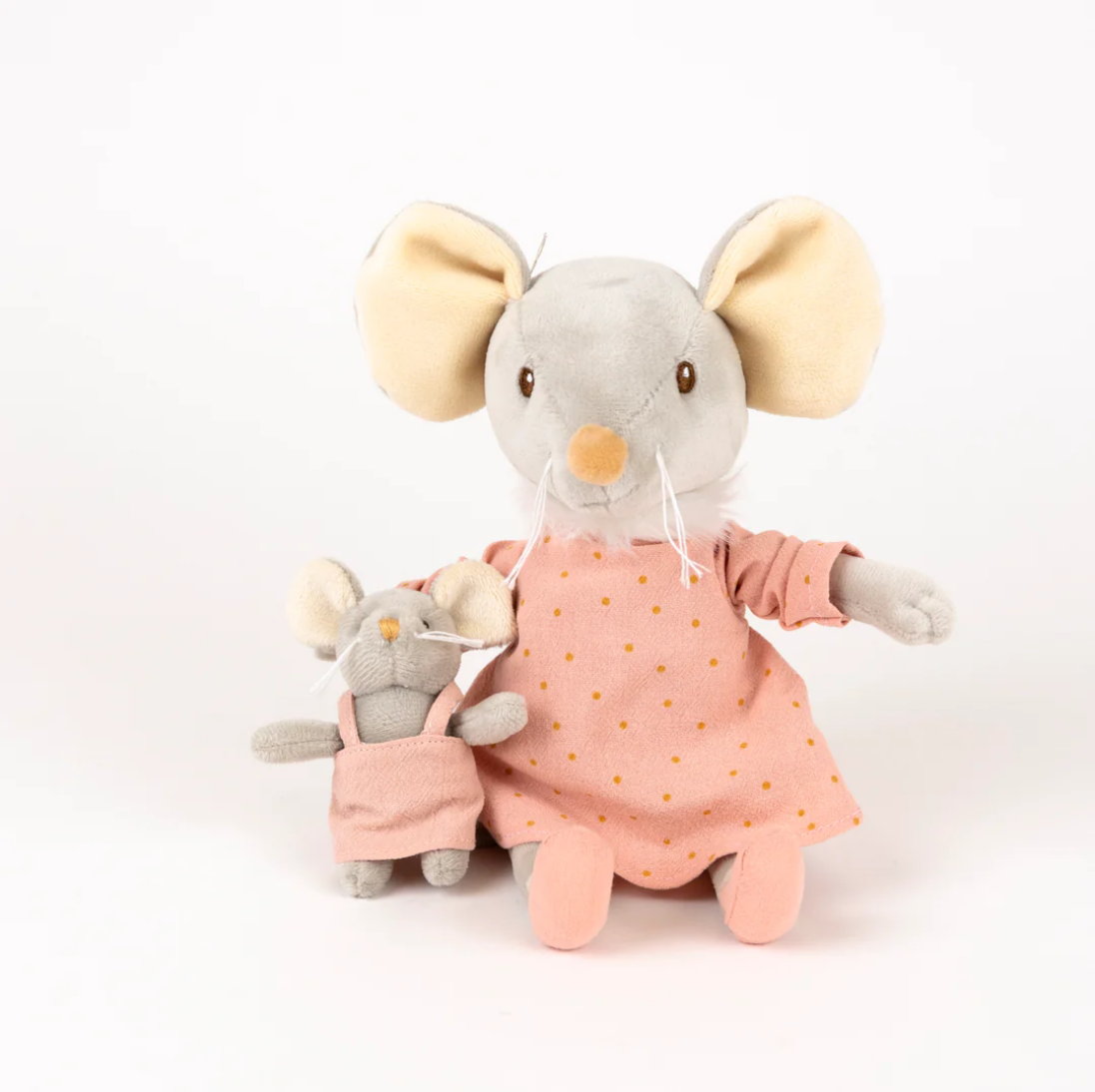 Plush mouse toys in pink dresses on a white background