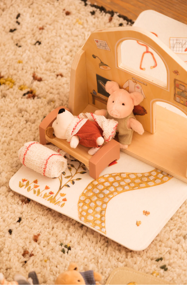 Wooden toy set with animals on a carpeted floor