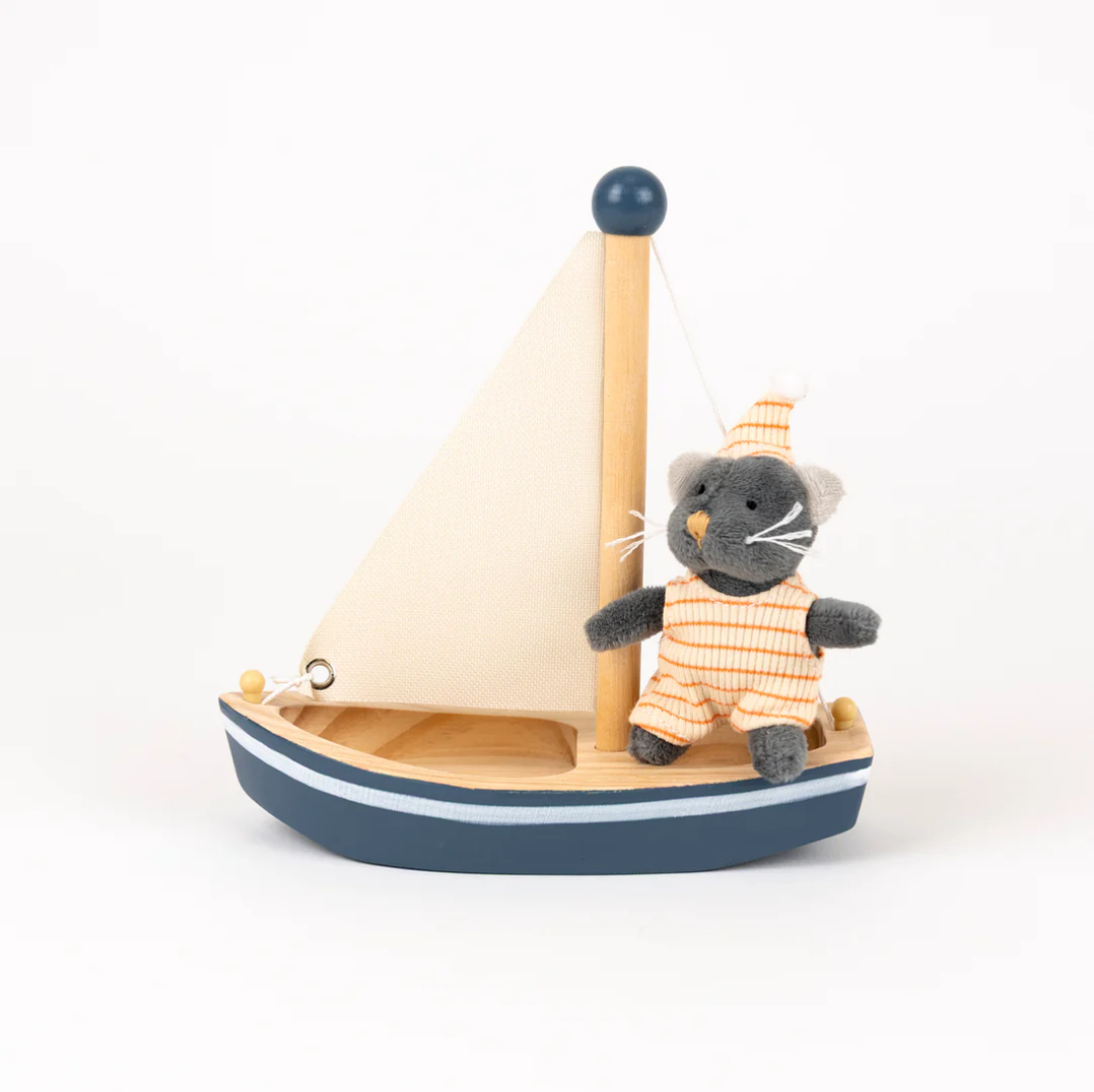 Toy sailboat with a cat figure on a white background