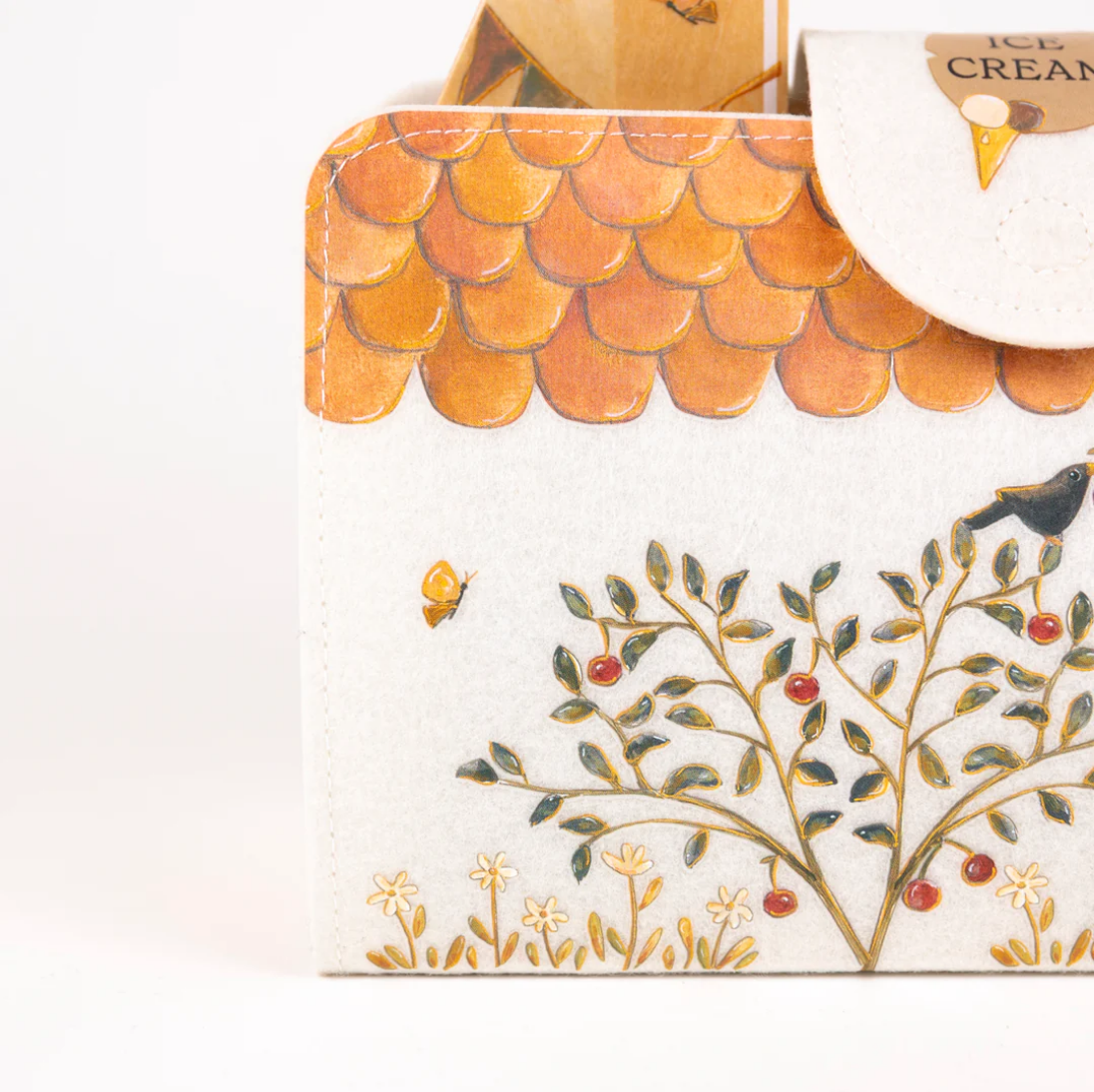 Close-up of a decorative box with a tree design and ice cream cone on top.