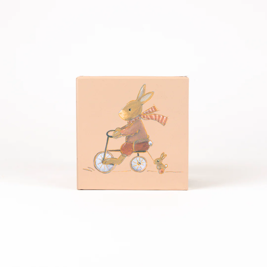 box with a rabbit riding a bicycle and a smaller rabbit in the background on a peach-colored background