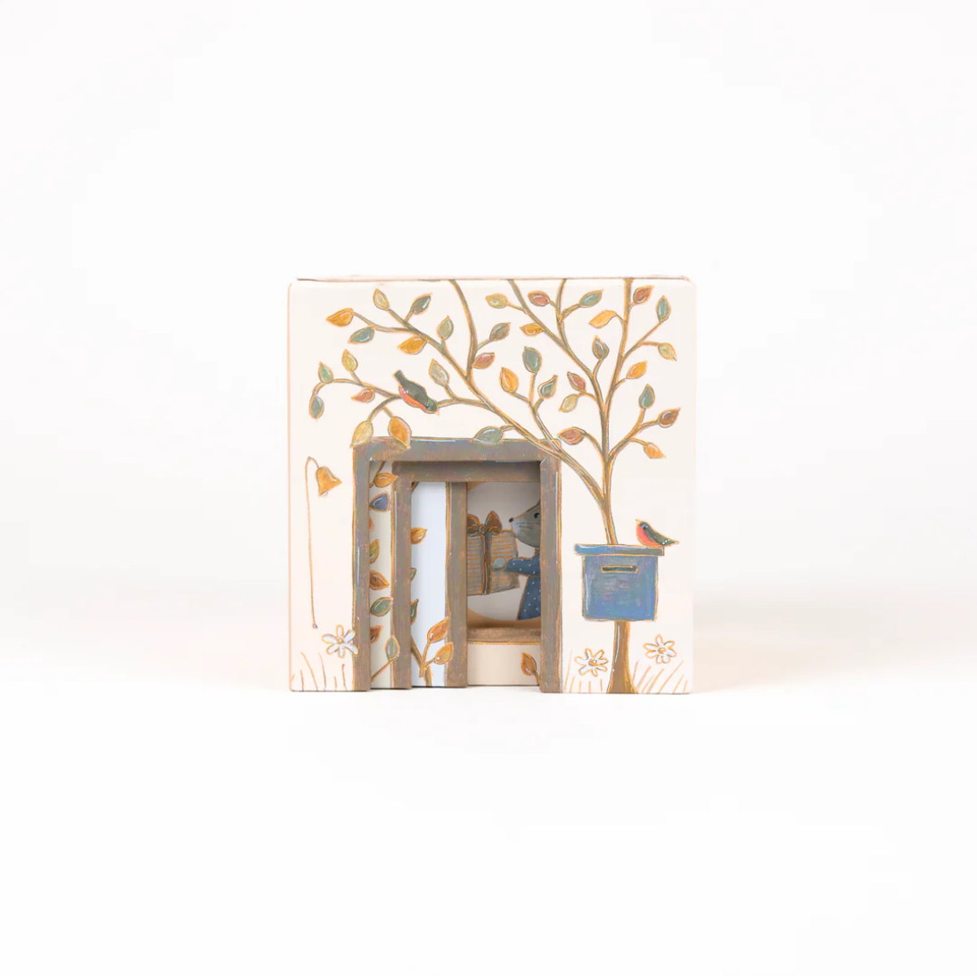 Decorative boxes with a tree design and small house inside, on a white background.