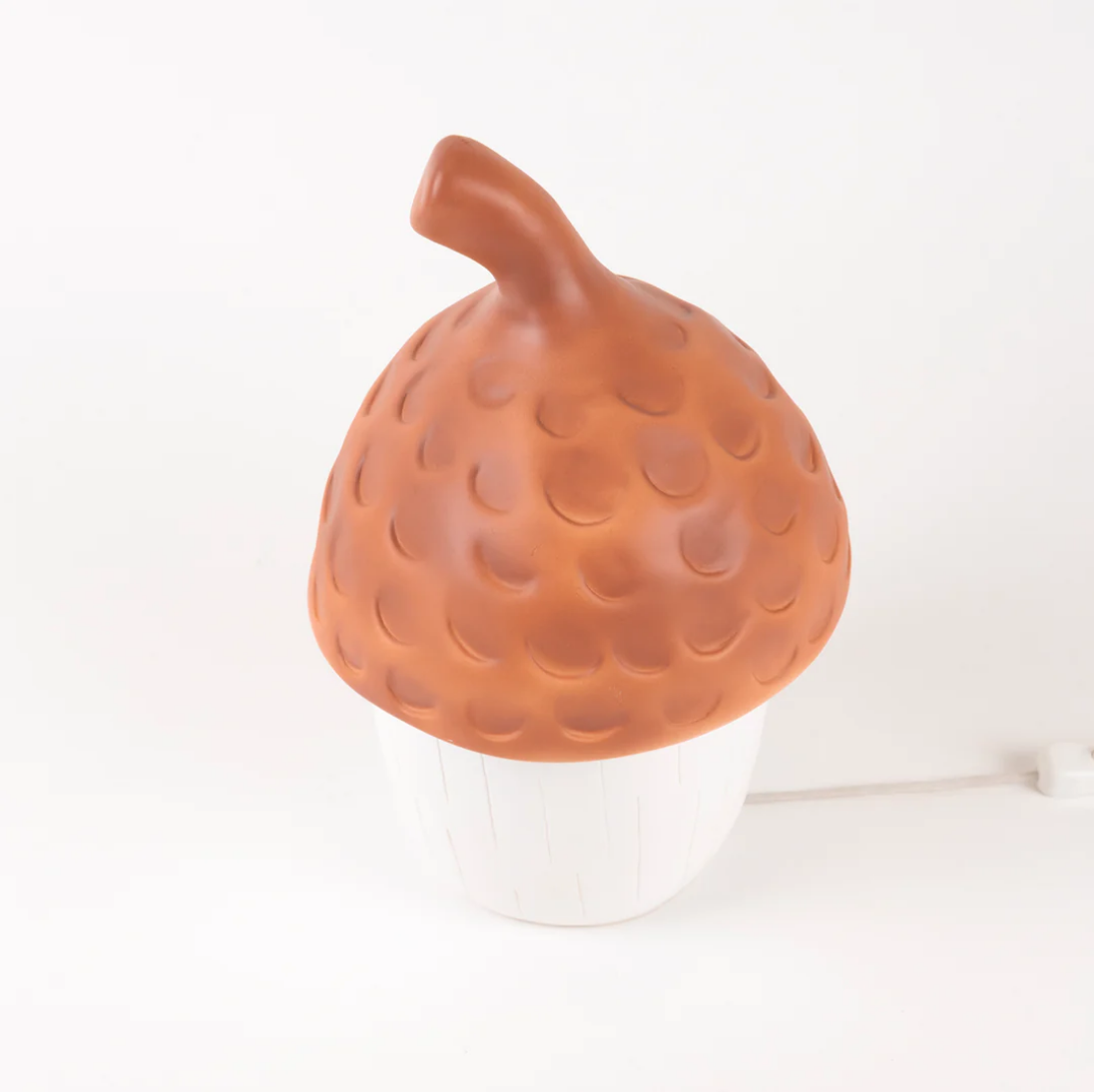 Orange textured object resembling a acorn on a white background