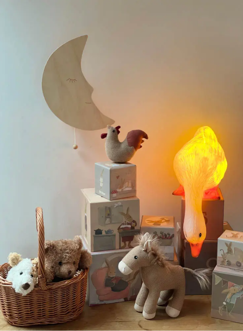Children's room with toys, a basket, and decorative items on a shelf.