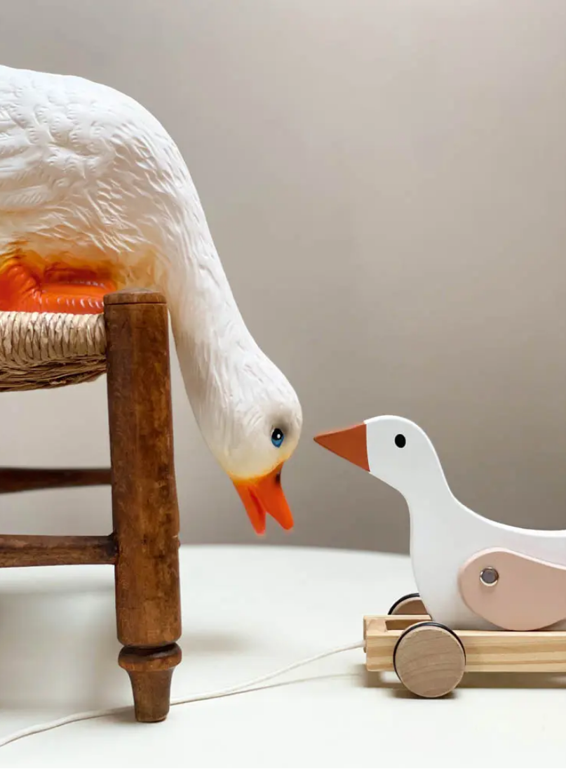goose lamp with a wooden goose toy on a light background