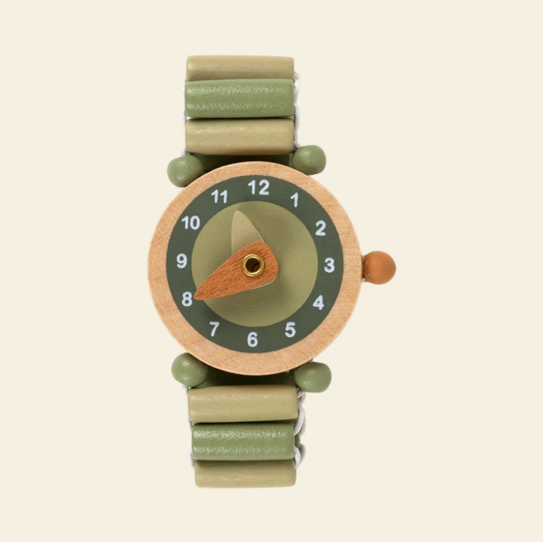 Children's watch with a green strap and wooden casing on a beige background
