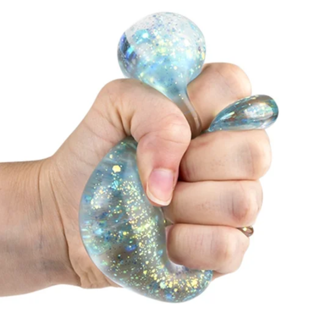 Hand holding a glittery blue stress ball 