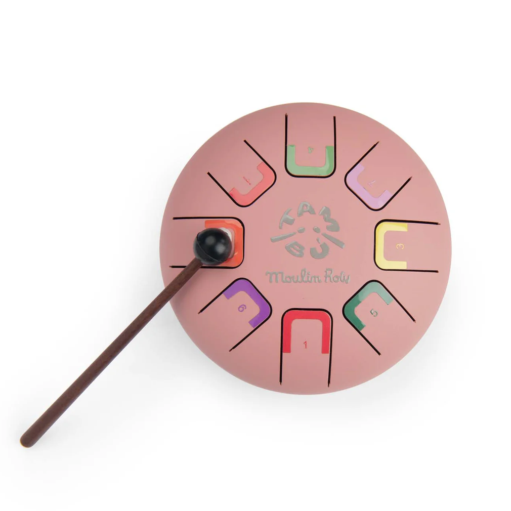 Pink circular musical instrument with colorful notations and a stick on a white background
