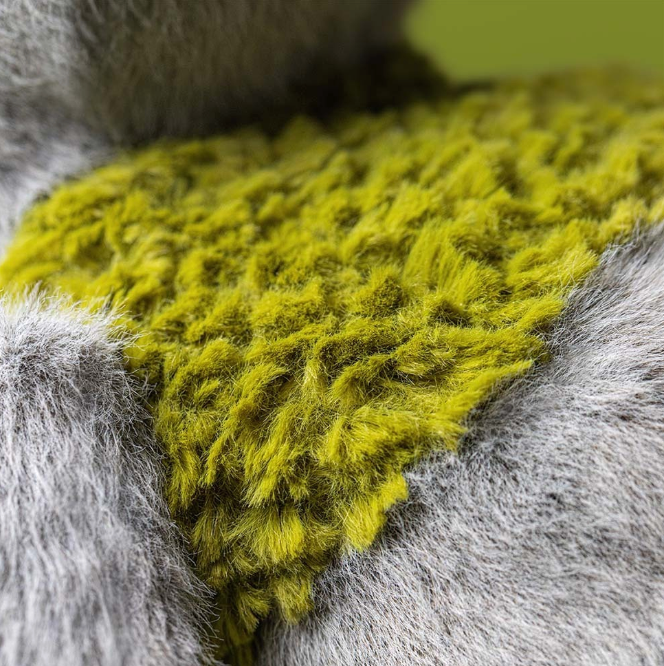 Close-up of a textured green fabric on a gray surface