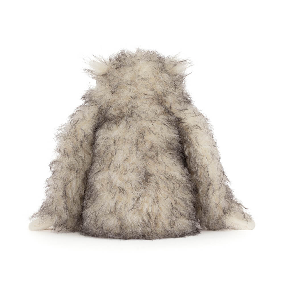 Furry toy resembling a creature on a white background