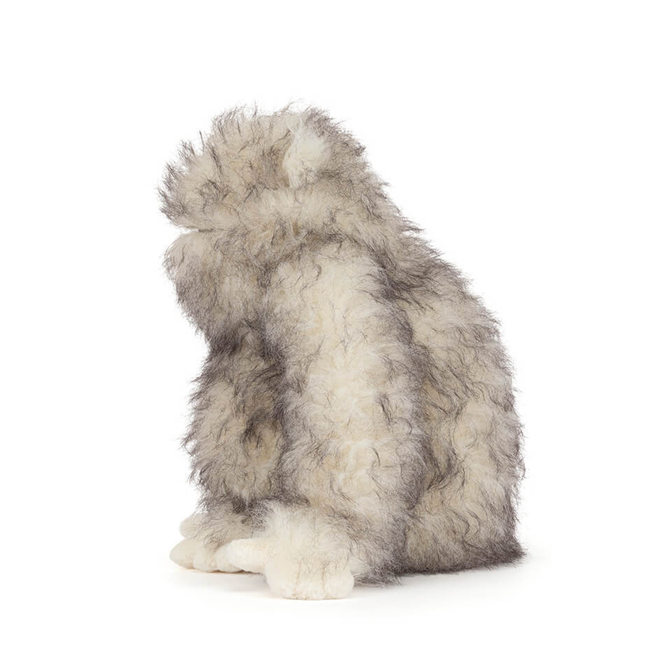 Plush toy resembling a fluffy creature on a white background