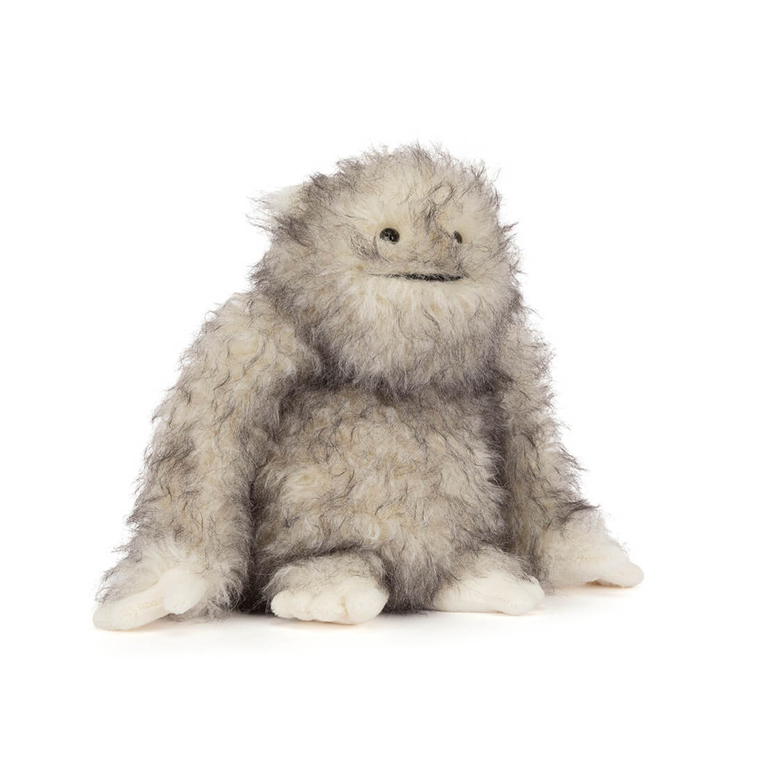 Plush toy resembling a gray creature on a white background