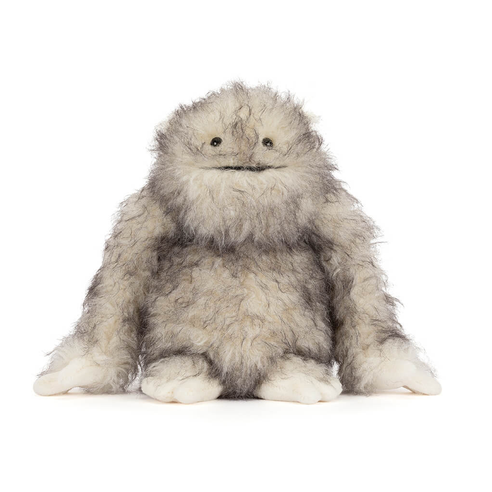 Plush toy resembling a fluffy creature on a white background
