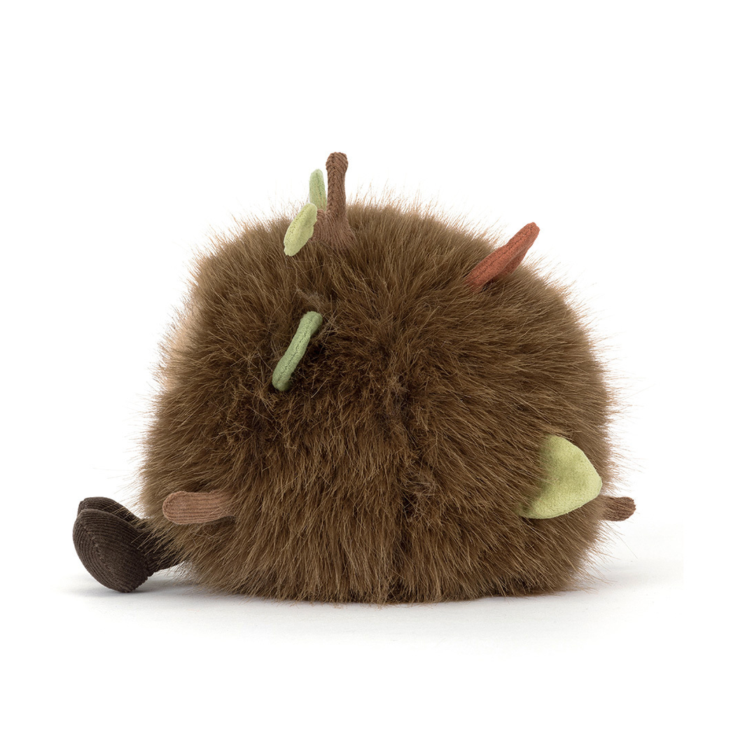 Brown plush toy with green accents on a white background