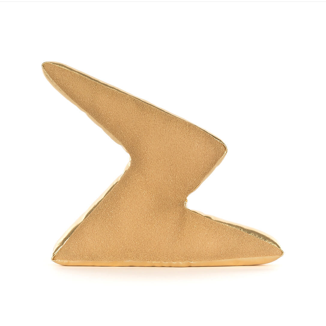 Gold decorative item with a zigzag pattern on a white background
