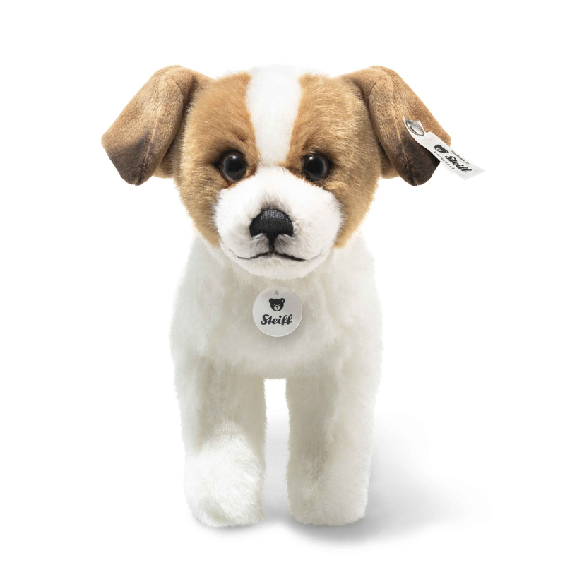 Stuffed dog toy with a tag on a white background