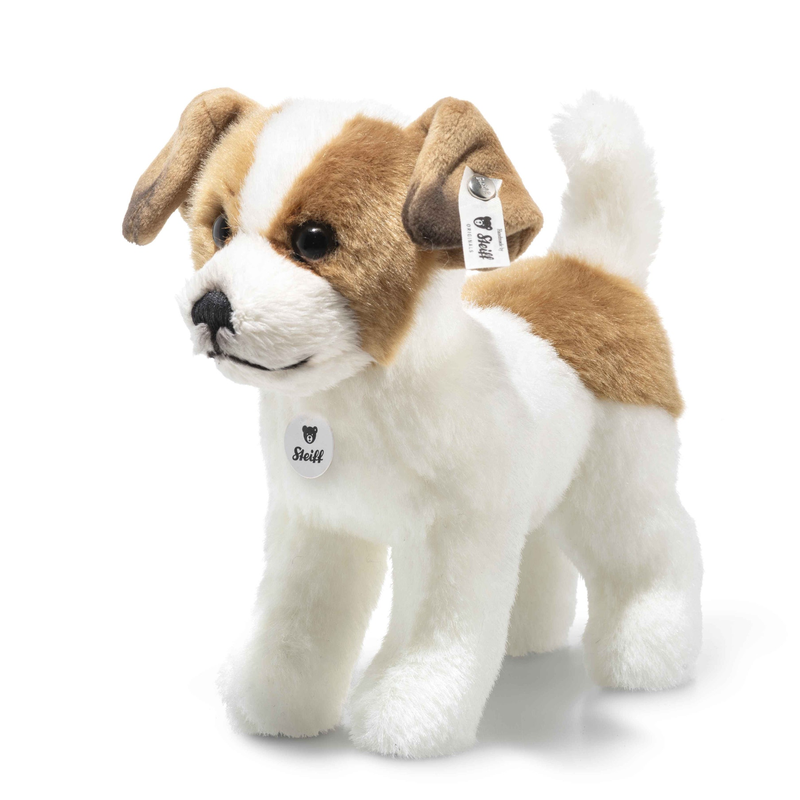 Stuffed dog toy with a tag on a white background