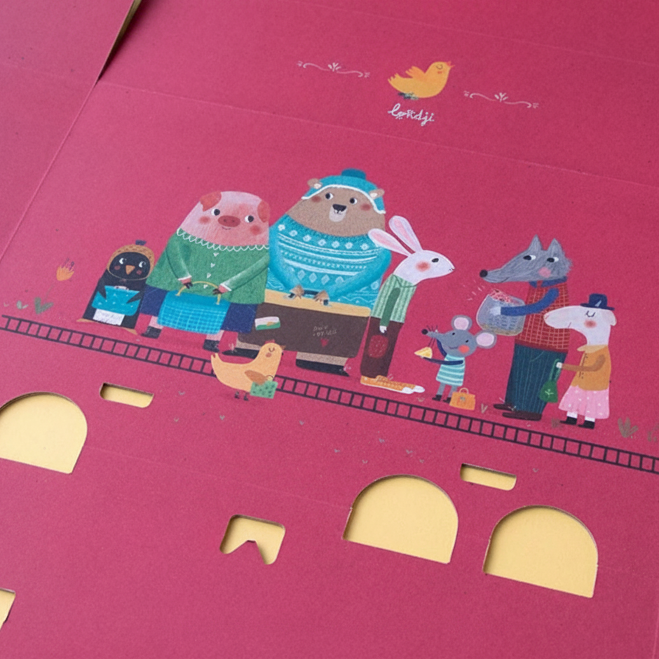 Pink packaging with cartoon animal characters and cutout shapes on a pink background