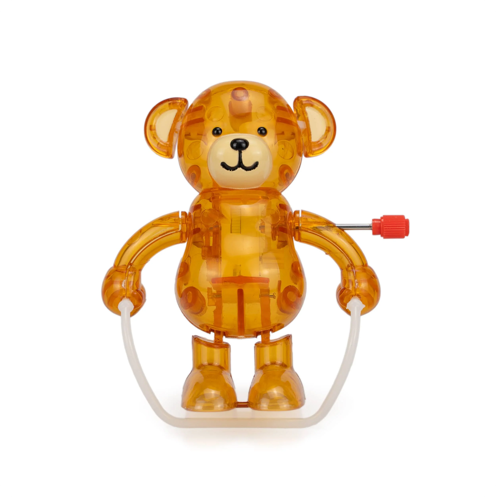 Transparent orange bear toy with a white jump rope on a white background