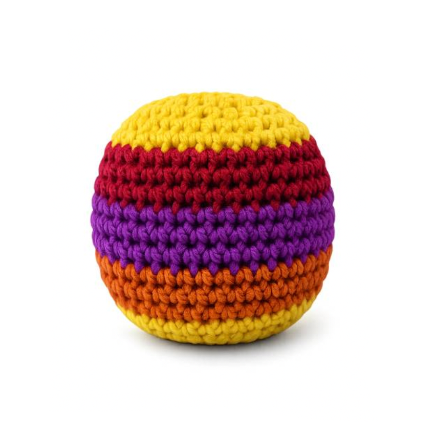 A crocheted round footbag with horizontal stripes of yellow, red, purple, orange, and brown