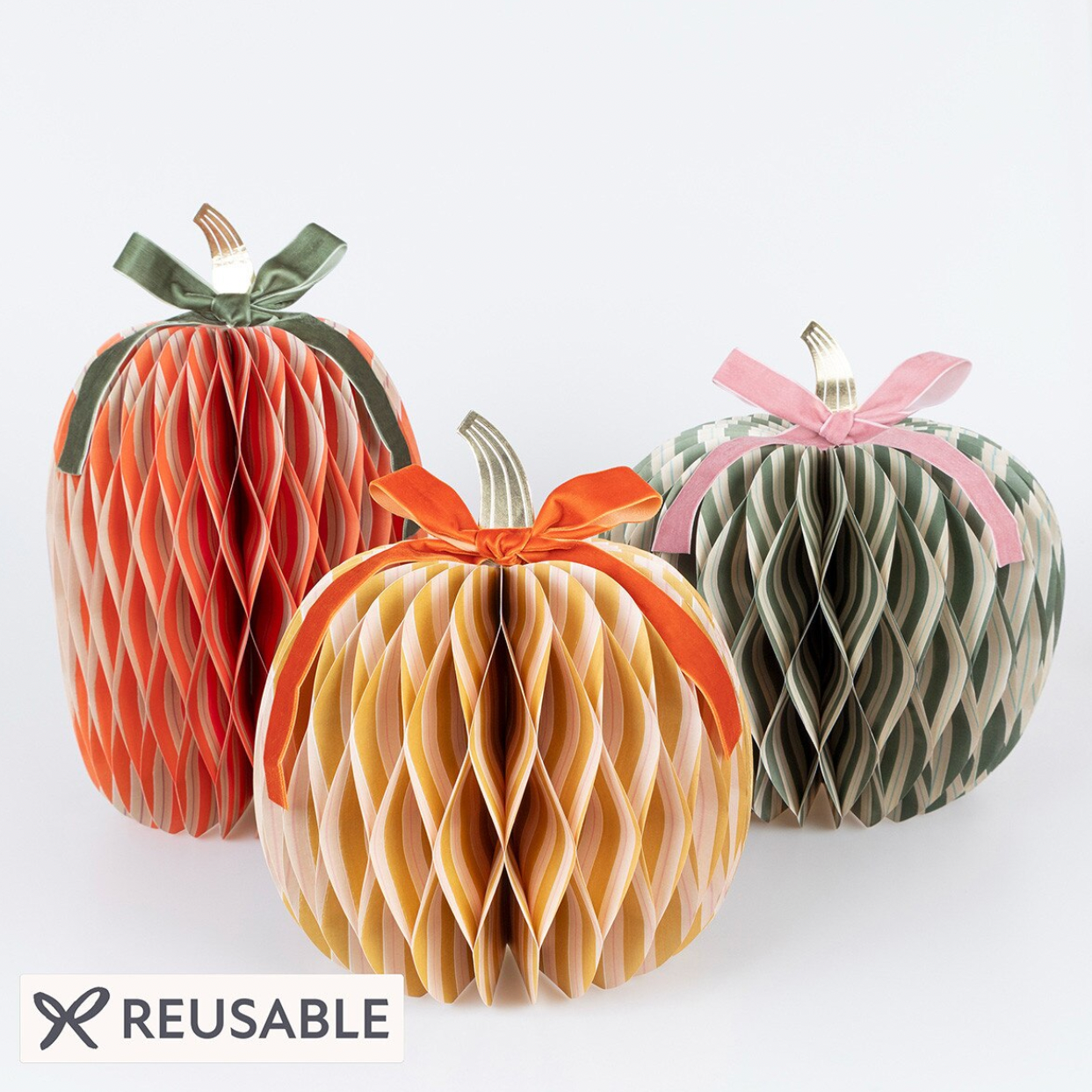 Three reusable honeycomb paper pumpkin decorations in autumn colors, featuring orange, beige, and green patterns with ribbon bows, on a white background with a 'REUSABLE' label.