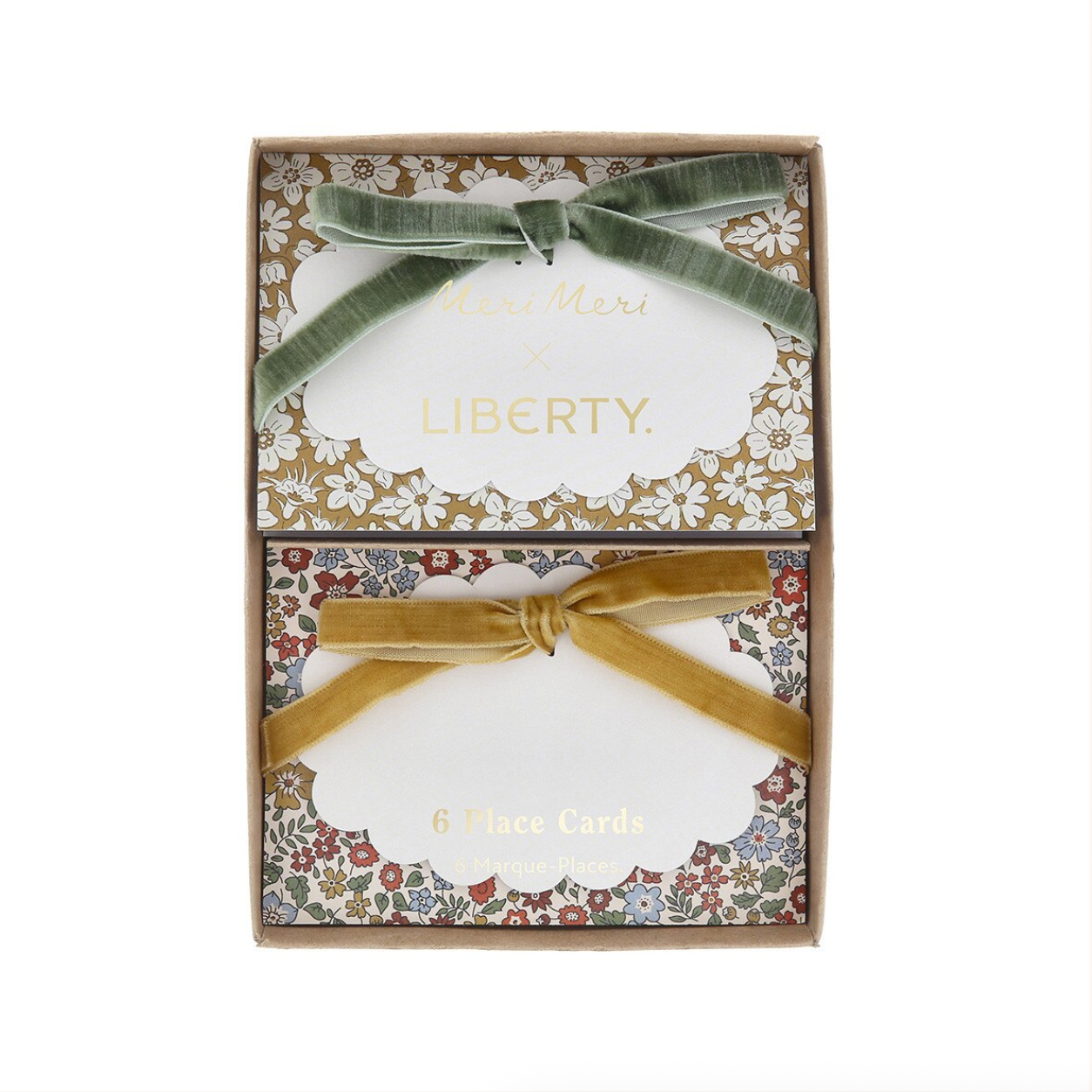 A boxed set of 6 place cards from Liberty, presented in a square gift box with floral-patterned borders and two ribbon bows, one green and one gold, on a white background.