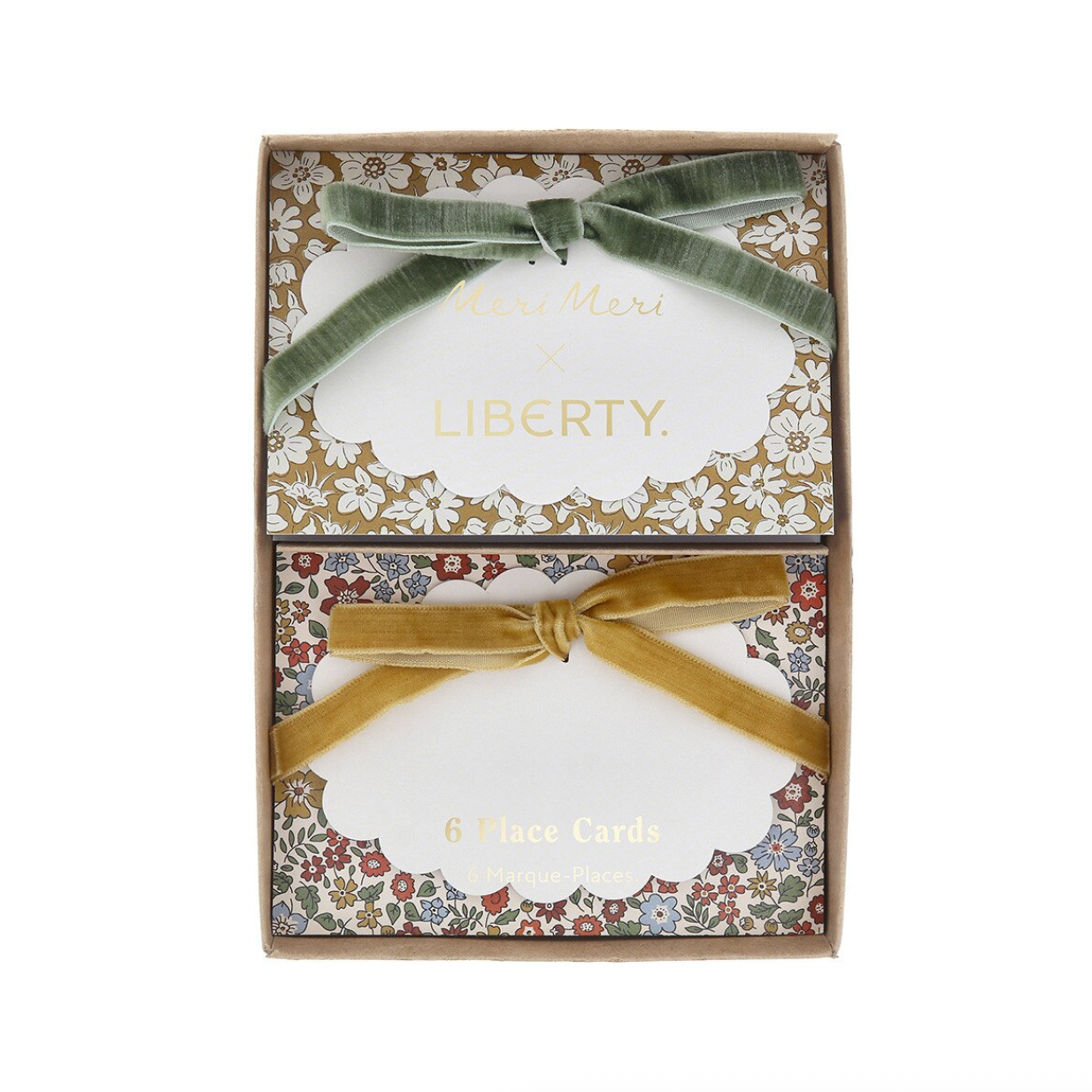 A boxed set of Liberty x Miss Me Me Me card games, featuring two rectangular boxes stacked vertically. The top box is decorated with a sage green velvet ribbon bow and the bottom box with a champagne gold velvet ribbon bow.