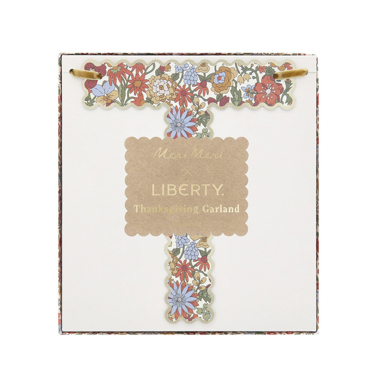 A square white card featuring a decorative floral garland shaped like the letter T, with a central scalloped label reading 'Merci Merci x LIBERTY Thanksgiving Garland.' The card is photographed against a plain white background.