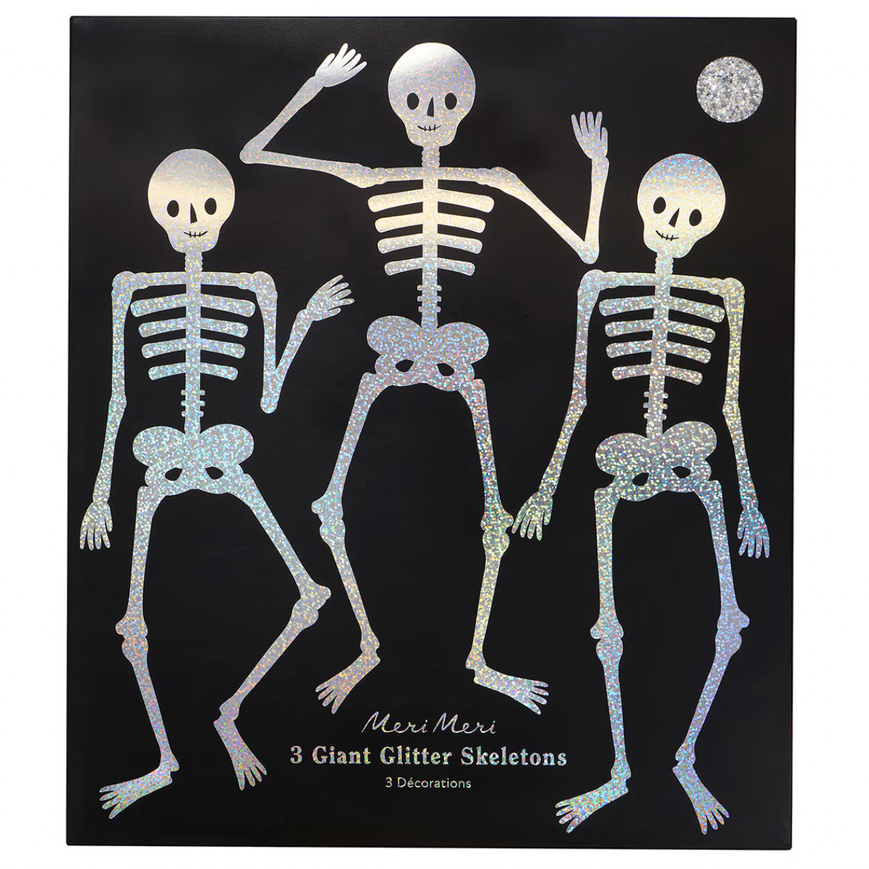 A black square art print or card featuring three glittery skeleton figures in white and iridescent silver tones, with a small silver moon at the top right and text at the bottom reading 'Meri Meri 3 Giant Glitter Skeletons 5 Glittercoins'.