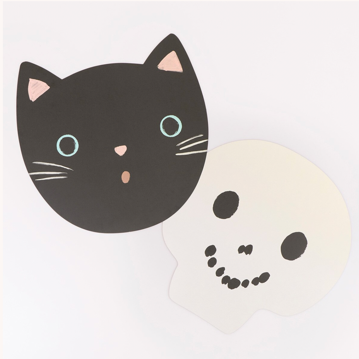 A pair of cartoon face stickers on a white background, featuring a black cat face with light blue eyes and a white ghost face with a black smile.