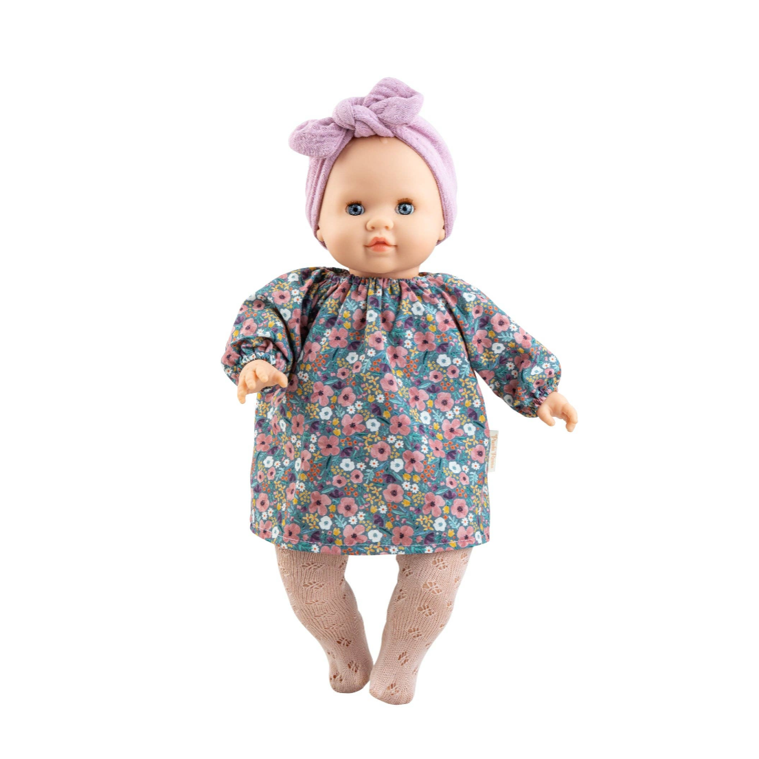 A baby doll with a purple bow headband and a long-sleeve floral dress, standing against a white background.