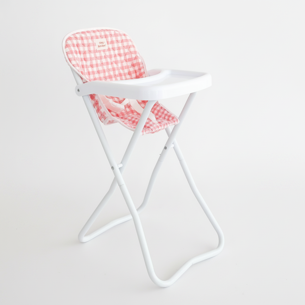 A white folding baby high chair with a pink and white gingham check patterned seat cushion, shown against a plain white background.