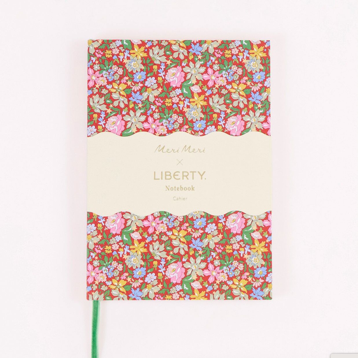 A notebook with a cream-colored center label and two floral patterned sections at the top and bottom, shown on a plain white background. The label reads 'Meri Meri x LIBERTY Notebook'.