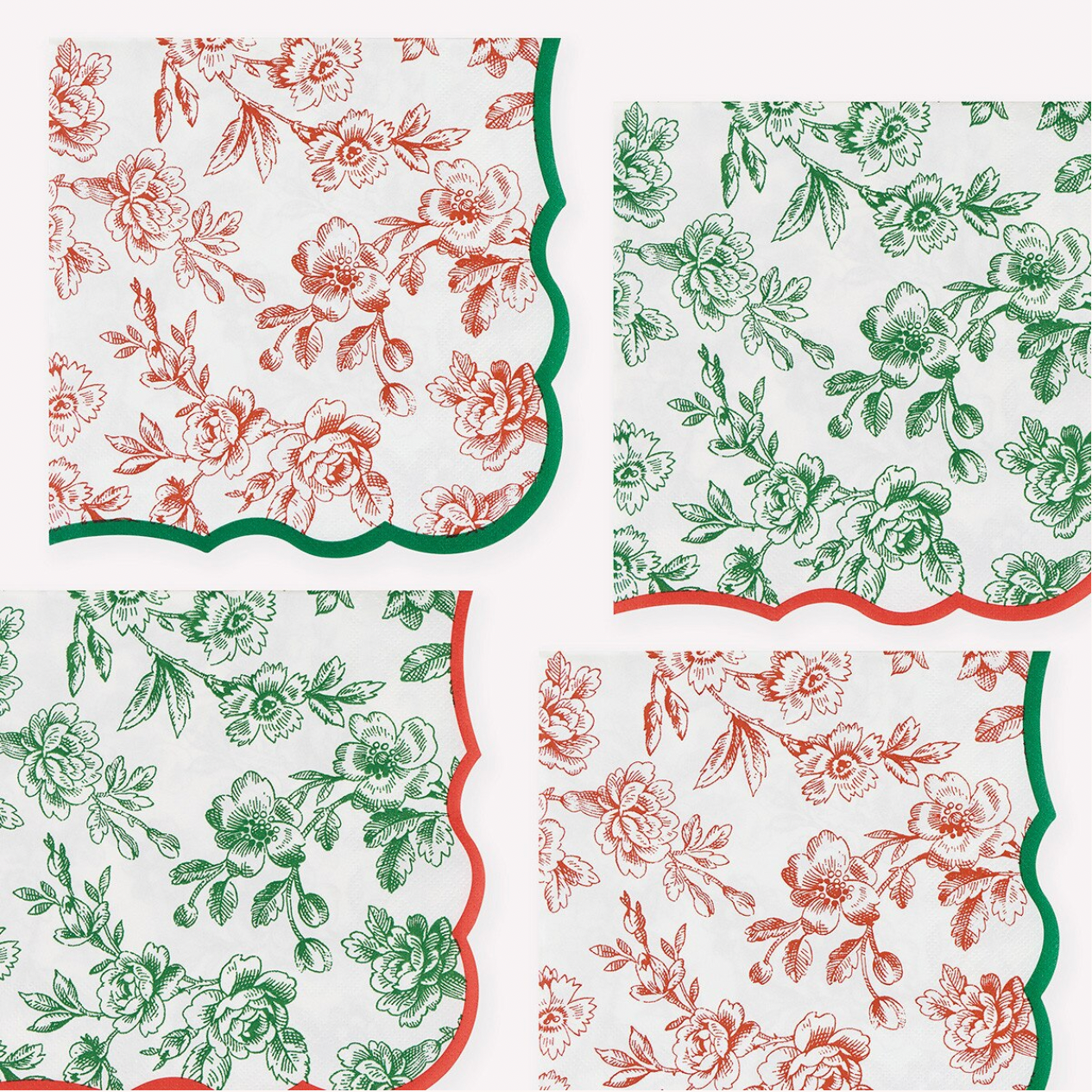 Four square napkins with scalloped edges arranged in a 2x2 grid on a white background. Two napkins feature a red floral toile pattern with green borders, and two feature a green floral toile pattern with red borders.