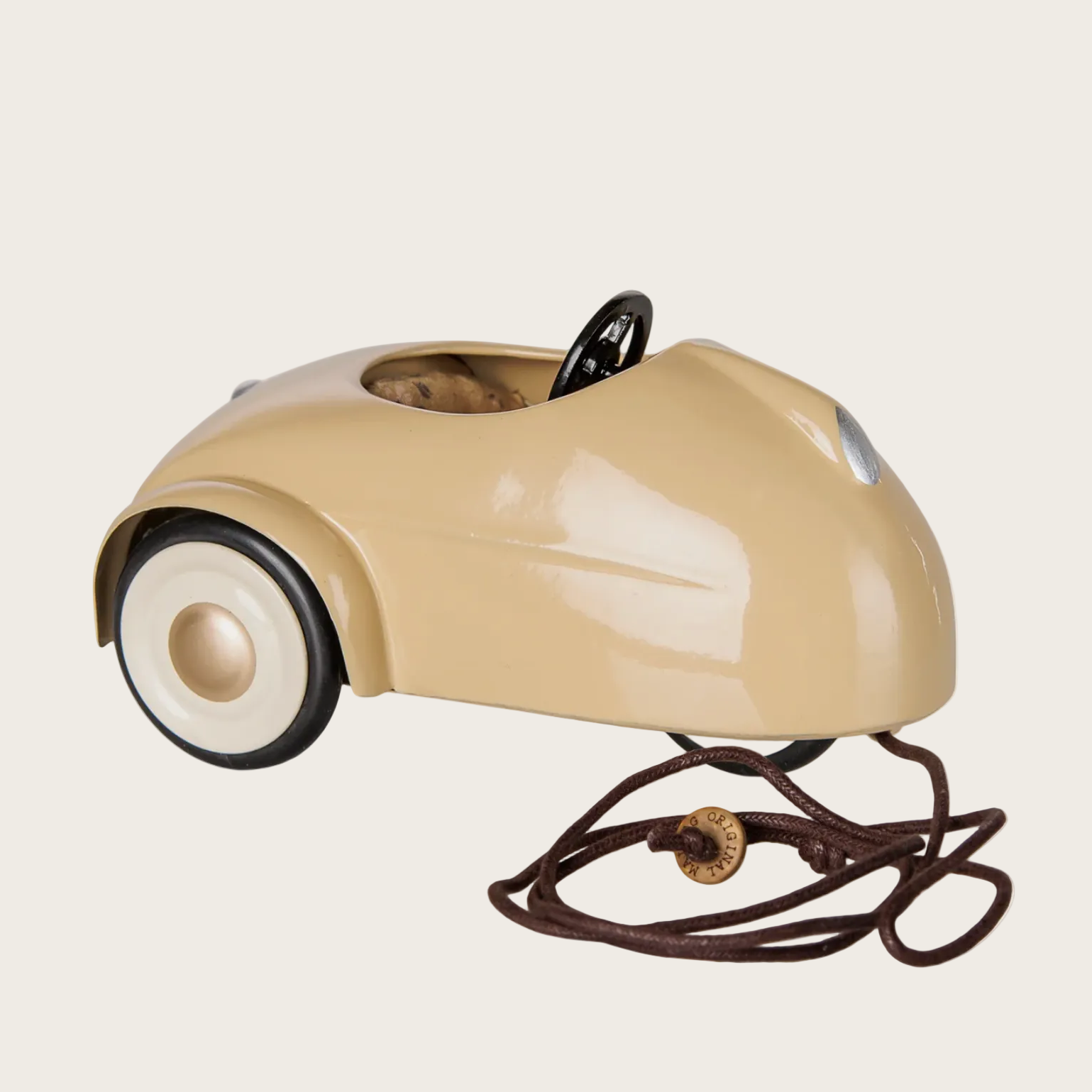 A vintage-style car mouse toy in a glossy beige shell with black wheels and a brown handle
