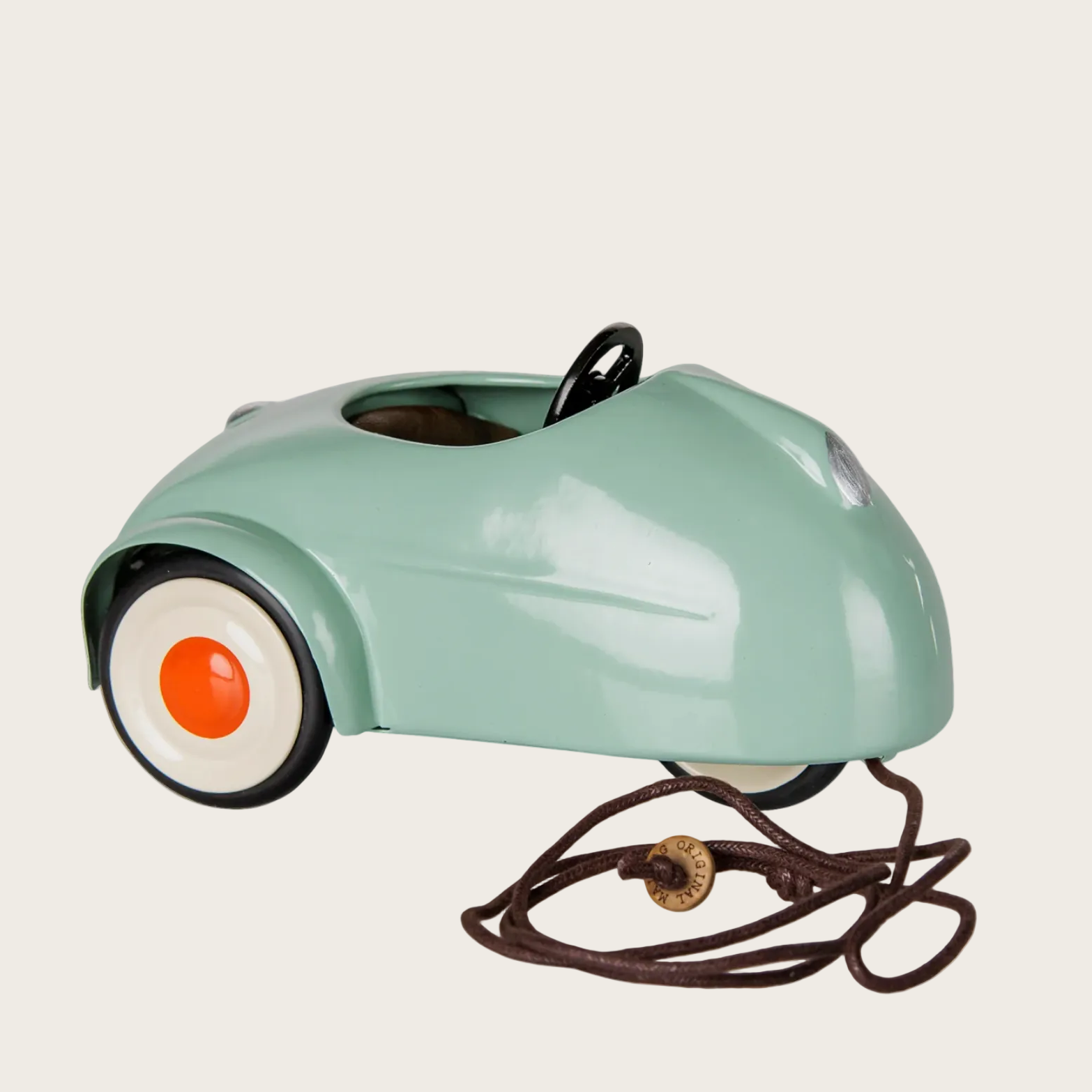 A screenshot of a Shopify website showing a vintage-style metal mouse car accessory in light mint green with orange wheels and a black cord