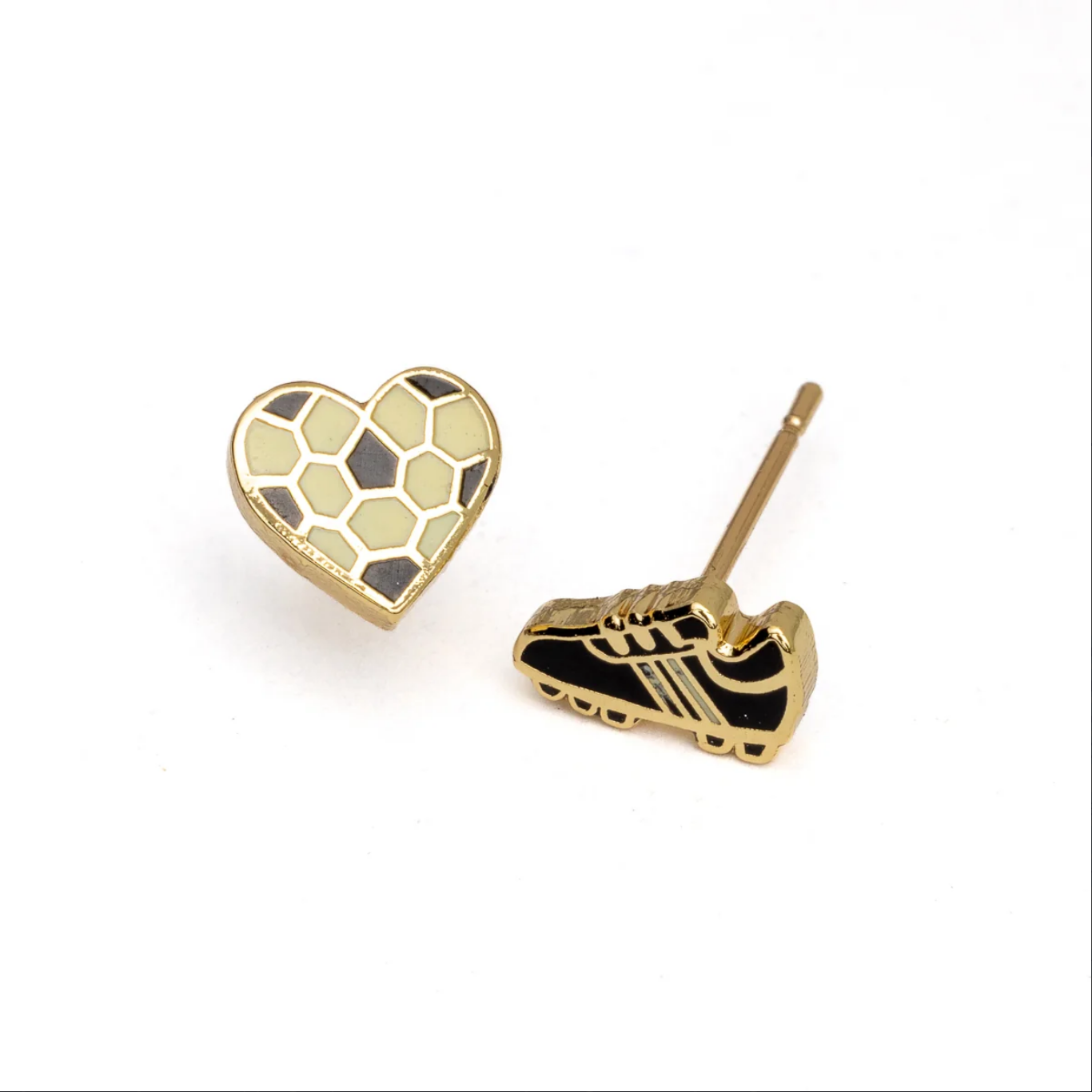 A pair of gold-tone stud earrings on a white background, featuring a heart-shaped earring with a soccer ball pattern and a soccer cleat earring with black and gold detailing.