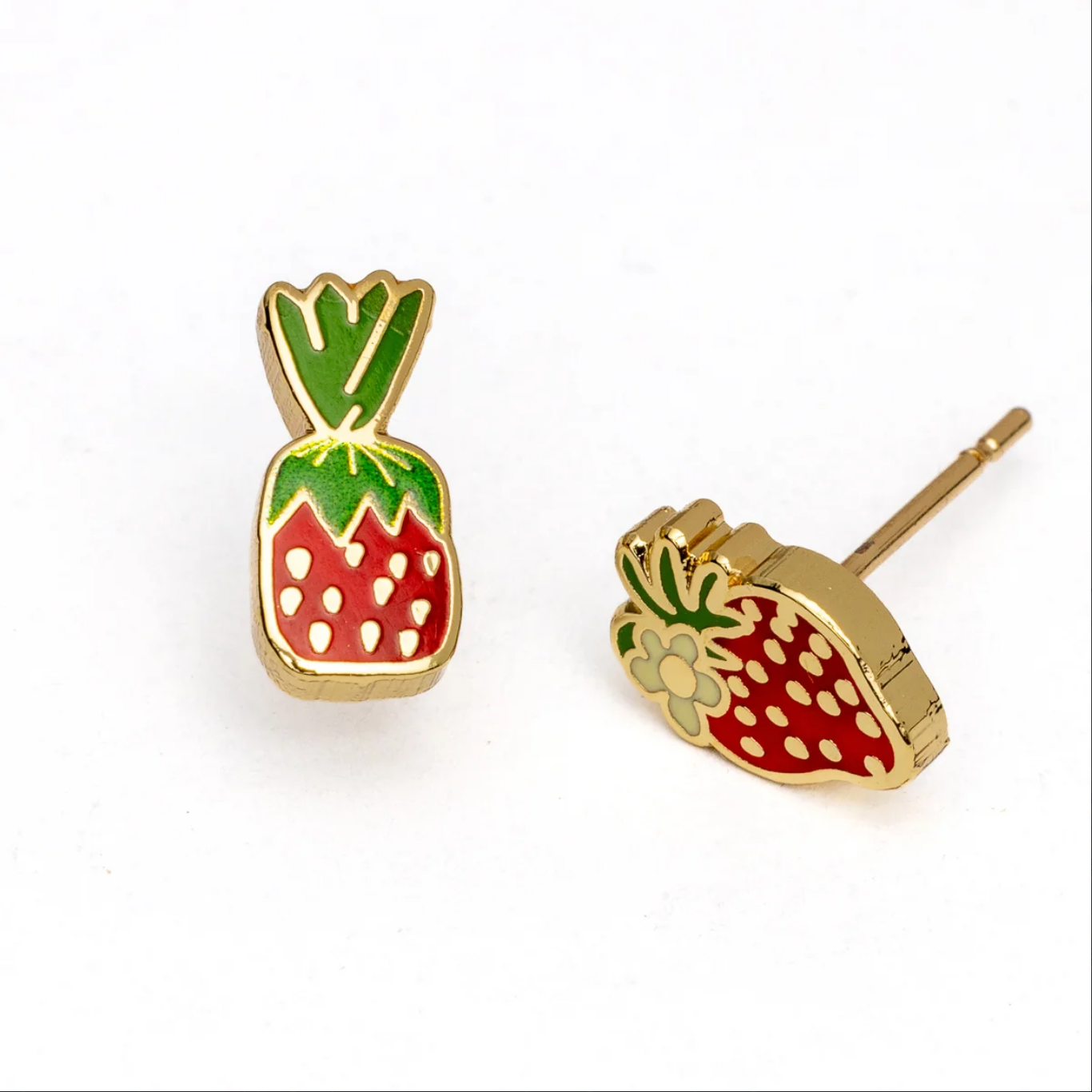Strawberry-shaped earrings with gold and green accents on a white background