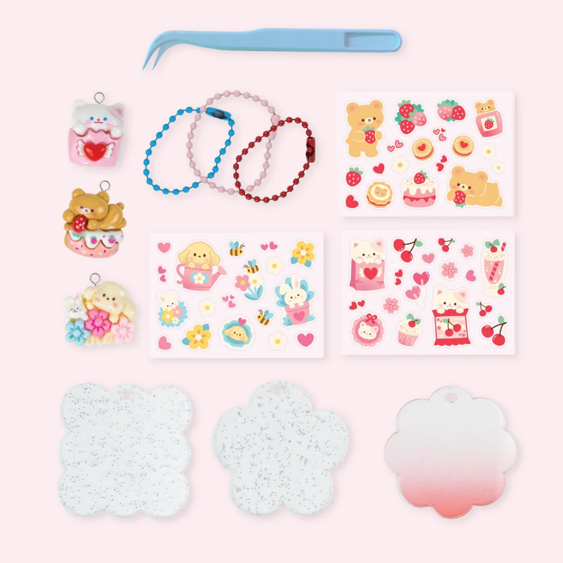 Set of small toys, accessories, and stationery items on a pink background