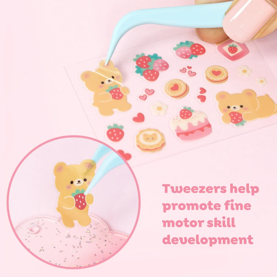 A hand using light blue tweezers to place a strawberry-holding teddy bear sticker on a clear sticker sheet. The sheet contains other cute stickers like strawberries, cakes, and cookies.